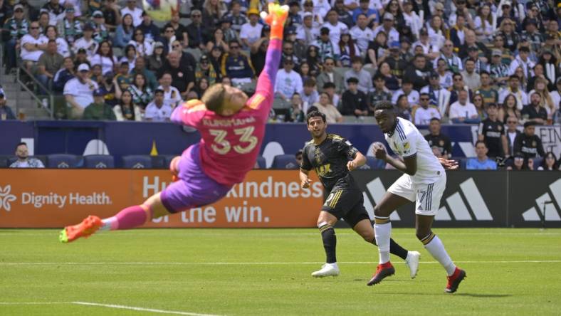 Apr 16, 2023; Carson, California, USA; Los Angeles FC forward Carlos Vela (10) scores a goal past Los Angeles Galaxy goalkeeper Jonathan Klinsmann and midfielder Memo Rodriguez (17) in the first half at Dignity Health Sports Park. Mandatory Credit: Jayne Kamin-Oncea-USA TODAY Sports