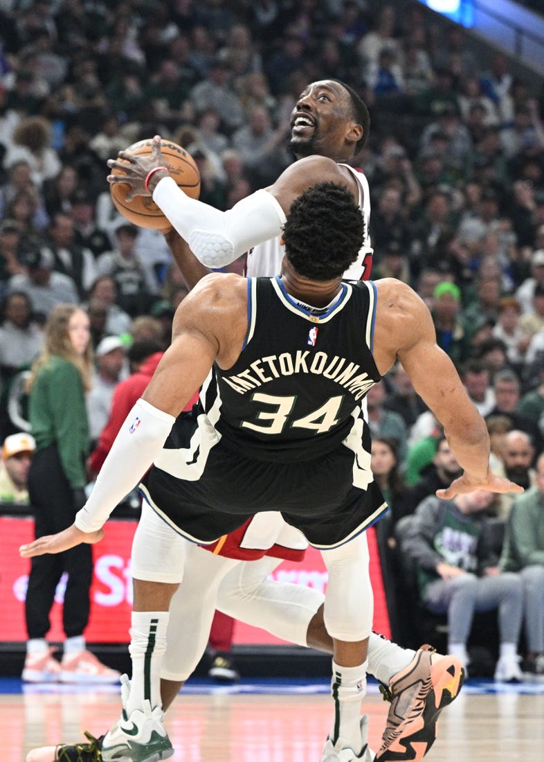 Apr 16, 2023; Milwaukee, Wisconsin, USA; Miami Heat center Bam Adebayo (13) drives against Milwaukee Bucks forward Giannis Antetokounmpo (34) in the first half during game one of the 2023 NBA Playoffs at Fiserv Forum. Mandatory Credit: Michael McLoone-USA TODAY Sports