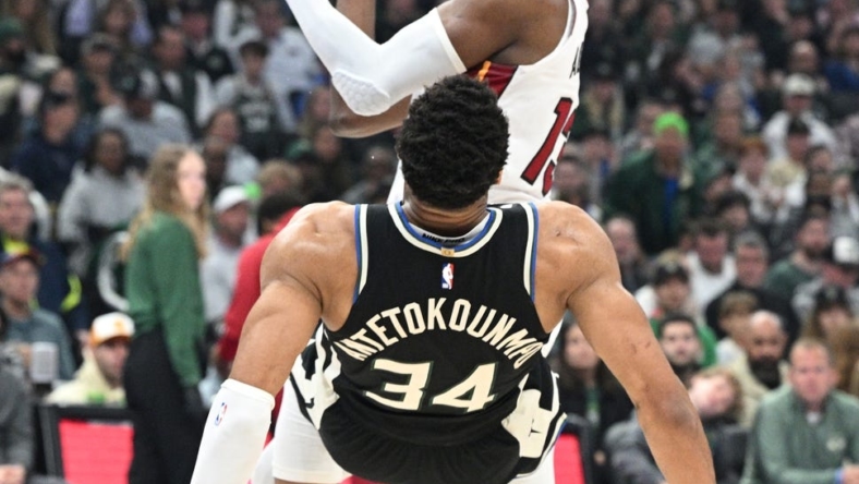 Apr 16, 2023; Milwaukee, Wisconsin, USA; Miami Heat center Bam Adebayo (13) drives against Milwaukee Bucks forward Giannis Antetokounmpo (34) in the first half during game one of the 2023 NBA Playoffs at Fiserv Forum. Mandatory Credit: Michael McLoone-USA TODAY Sports
