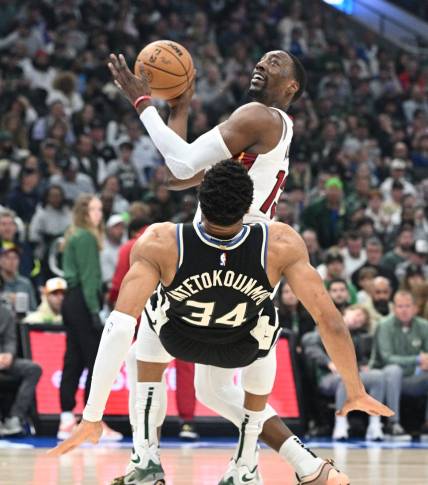 Apr 16, 2023; Milwaukee, Wisconsin, USA; Miami Heat center Bam Adebayo (13) drives against Milwaukee Bucks forward Giannis Antetokounmpo (34) in the first half during game one of the 2023 NBA Playoffs at Fiserv Forum. Mandatory Credit: Michael McLoone-USA TODAY Sports