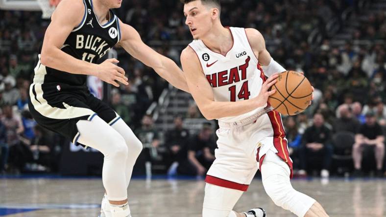 Apr 16, 2023; Milwaukee, Wisconsin, USA; Miami Heat guard Tyler Herro (14) drives against Milwaukee Bucks guard Jrue Holiday (21) in the first half during game one of the 2023 NBA Playoffs at Fiserv Forum. Mandatory Credit: Michael McLoone-USA TODAY Sports