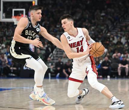 Apr 16, 2023; Milwaukee, Wisconsin, USA; Miami Heat guard Tyler Herro (14) drives against Milwaukee Bucks guard Jrue Holiday (21) in the first half during game one of the 2023 NBA Playoffs at Fiserv Forum. Mandatory Credit: Michael McLoone-USA TODAY Sports