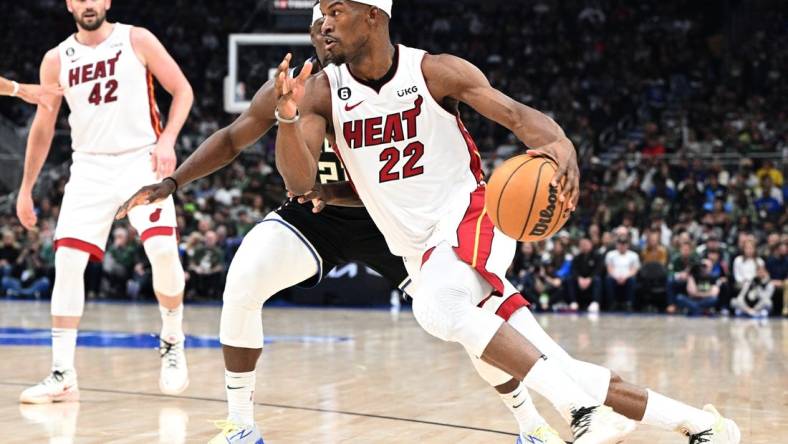 Apr 16, 2023; Milwaukee, Wisconsin, USA; Miami Heat forward Jimmy Butler (22) drives to the basket against Milwaukee Bucks guard Jrue Holiday (21) in the first half during game one of the 2023 NBA Playoffs at Fiserv Forum. Mandatory Credit: Michael McLoone-USA TODAY Sports