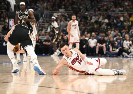 Apr 16, 2023; Milwaukee, Wisconsin, USA; Miami Heat guard Tyler Herro (14) injures his hand while diving for a loose ball against the Milwaukee Bucks during game one of the 2023 NBA Playoffs at Fiserv Forum. Mandatory Credit: Michael McLoone-USA TODAY Sports