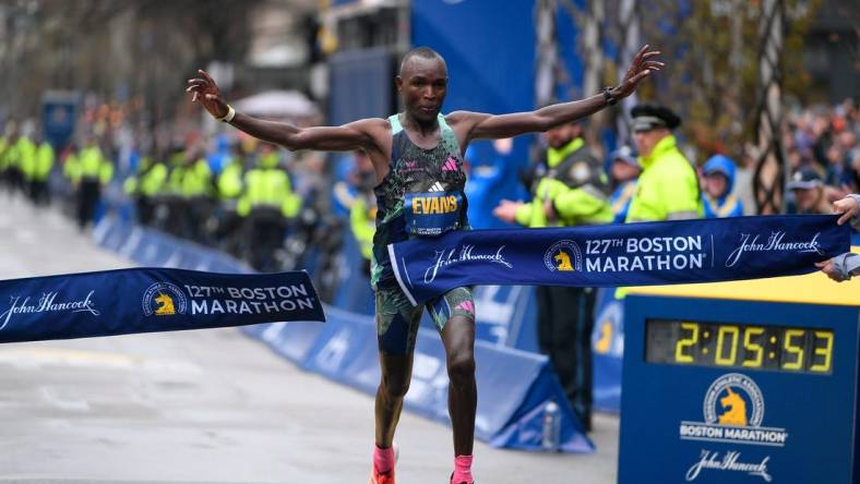 Apr 17, 2023; Boston, MA, USA; Evans Chebet of Kenya crosses the finish line to win the men's division at then 2023 Boston Marathon.  Mandatory Credit: Eric Canha-USA TODAY Sports