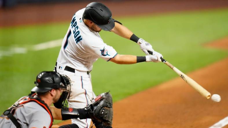 Apr 17, 2023; Miami, Florida, USA; Miami Marlins shortstop Garrett Hampson (1) hits a single against the San Francisco Giants during the sixth inning at loanDepot Park. Mandatory Credit: Rich Storry-USA TODAY Sports