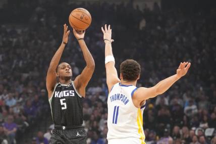 April 17, 2023; Sacramento, California, USA; Sacramento Kings guard De'Aaron Fox (5) shoots the basketball against Golden State Warriors guard Klay Thompson (11) during the first quarter in game two of the first round of the 2023 NBA playoffs at Golden 1 Center. Mandatory Credit: Kyle Terada-USA TODAY Sports