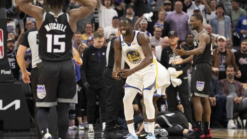 April 17, 2023; Sacramento, California, USA; Golden State Warriors forward Draymond Green (23) reacts towards the referee after a play with Sacramento Kings forward Domantas Sabonis (10) laying on the court during the fourth quarter in game two of the first round of the 2023 NBA playoffs at Golden 1 Center. Mandatory Credit: Kyle Terada-USA TODAY Sports