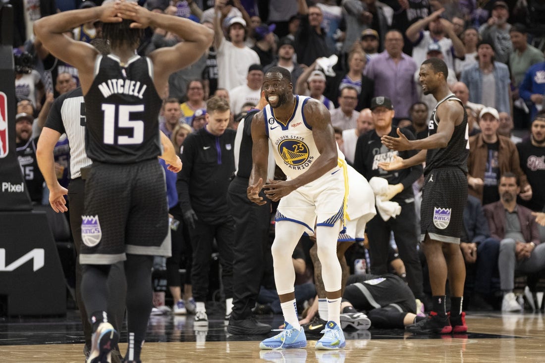 April 17, 2023; Sacramento, California, USA; Golden State Warriors forward Draymond Green (23) reacts towards the referee after a play with Sacramento Kings forward Domantas Sabonis (10) laying on the court during the fourth quarter in game two of the first round of the 2023 NBA playoffs at Golden 1 Center. Mandatory Credit: Kyle Terada-USA TODAY Sports