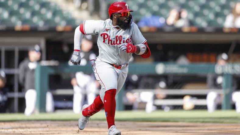 Apr 18, 2023; Chicago, Illinois, USA; Philadelphia Phillies second baseman Josh Harrison (2) runs to first base after hitting a two-run single against the Chicago White Sox during the third inning of game one of the doubleheader at Guaranteed Rate Field. Mandatory Credit: Kamil Krzaczynski-USA TODAY Sports