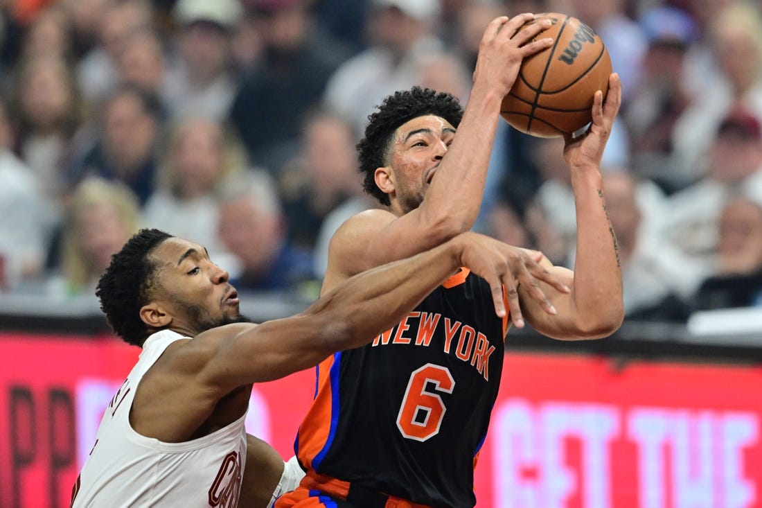 Apr 18, 2023; Cleveland, Ohio, USA; Cleveland Cavaliers guard Donovan Mitchell (45) fouls New York Knicks guard Quentin Grimes (6) during the first quarter of game two of the 2023 NBA playoffs at Rocket Mortgage FieldHouse. Mandatory Credit: Ken Blaze-USA TODAY Sports