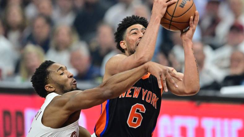 Apr 18, 2023; Cleveland, Ohio, USA; Cleveland Cavaliers guard Donovan Mitchell (45) fouls New York Knicks guard Quentin Grimes (6) during the first quarter of game two of the 2023 NBA playoffs at Rocket Mortgage FieldHouse. Mandatory Credit: Ken Blaze-USA TODAY Sports