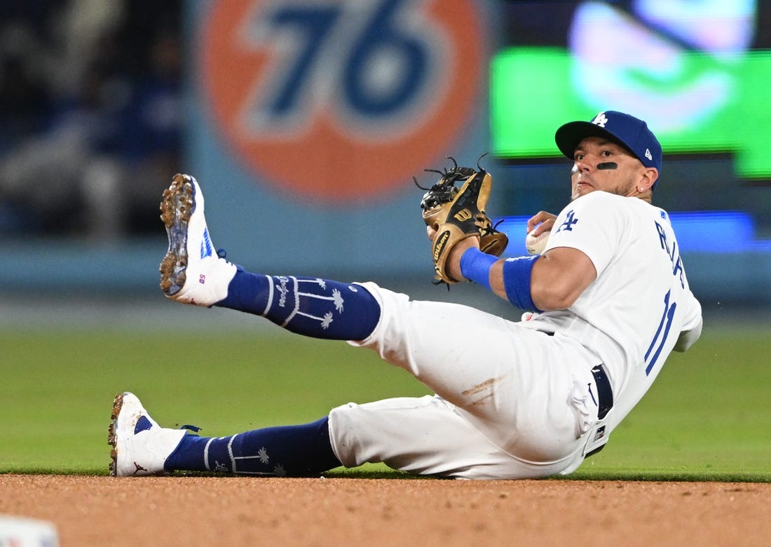 Apr 18, 2023; Los Angeles, California, USA; Los Angeles Dodgers shortstop Miguel Rojas (11) tries to make a play but can   t get New York Mets shortstop Francisco Lindor (12) out at first in the fourth inning at Dodger Stadium. Mandatory Credit: Jayne Kamin-Oncea-USA TODAY Sports