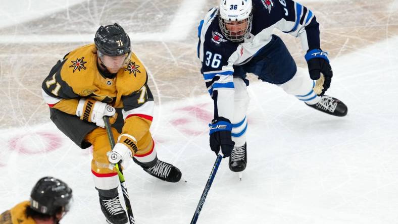 Apr 18, 2023; Las Vegas, Nevada, USA; Vegas Golden Knights center William Karlsson (71) skates against Winnipeg Jets center Morgan Barron (36) during the third period of game one of the first round of the 2023 Stanley Cup Playoffs at T-Mobile Arena. Mandatory Credit: Stephen R. Sylvanie-USA TODAY Sports