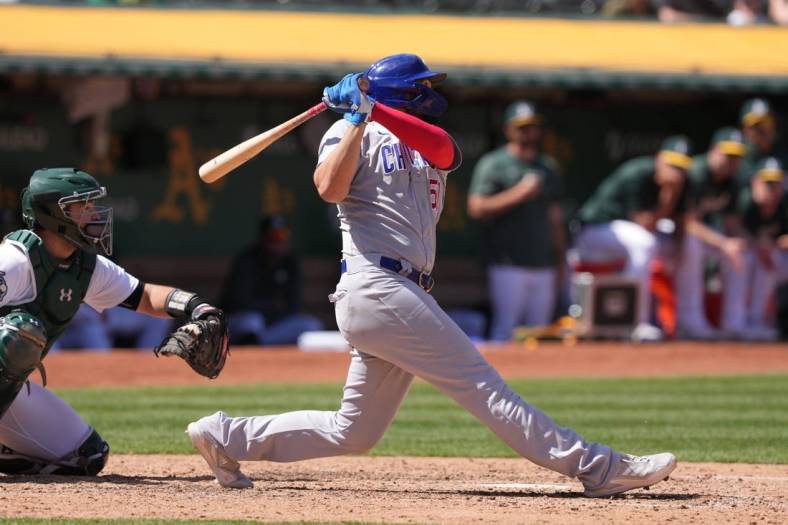 Apr 19, 2023; Oakland, California, USA; Chicago Cubs first baseman Eric Hosmer (51) hits a home run against the Oakland Athletics during the eighth inning at Oakland-Alameda County Coliseum. Mandatory Credit: Darren Yamashita-USA TODAY Sports