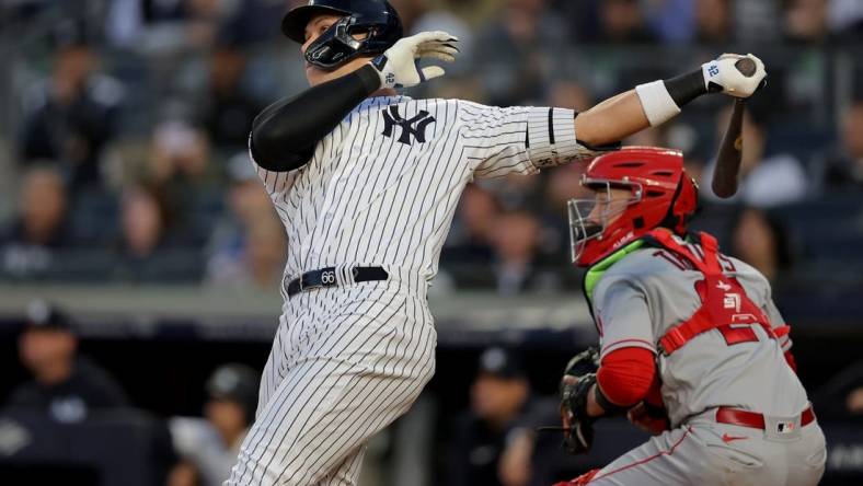 Apr 19, 2023; Bronx, New York, USA; New York Yankees center fielder Aaron Judge (99) follows through on a two run home run against the Los Angeles Angels during the first inning at Yankee Stadium. Mandatory Credit: Brad Penner-USA TODAY Sports