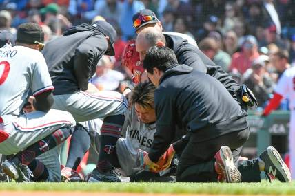 Apr 20, 2023; Boston, Massachusetts, USA; Minnesota Twins starting pitcher Kenta Maeda (18) is examined  after being struck by a ball hit by Boston Red Sox center fielder Jarren Duran (not pictured) at Fenway Park. Mandatory Credit: Eric Canha-USA TODAY Sports