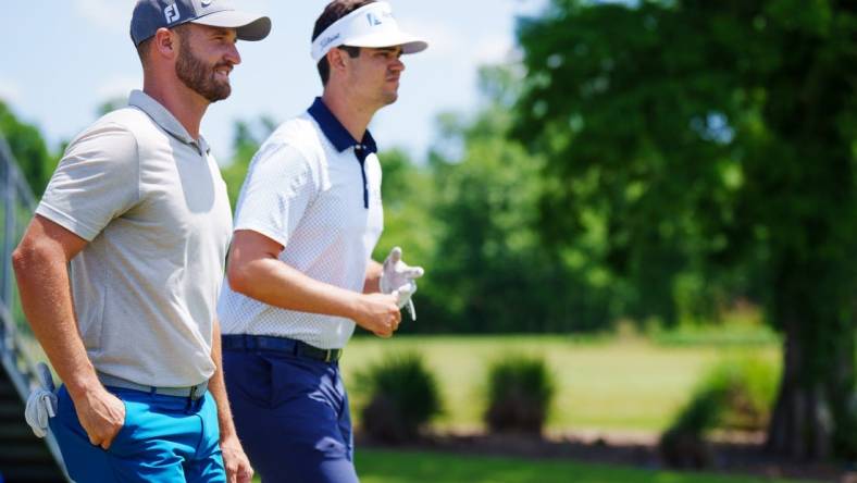 Apr 20, 2023; Avondale, Louisiana, USA; Wyndham Clark and Beau Hossler walk off the first tee during the first round of the Zurich Classic of New Orleans golf tournament. Mandatory Credit: Andrew Wevers-USA TODAY Sports