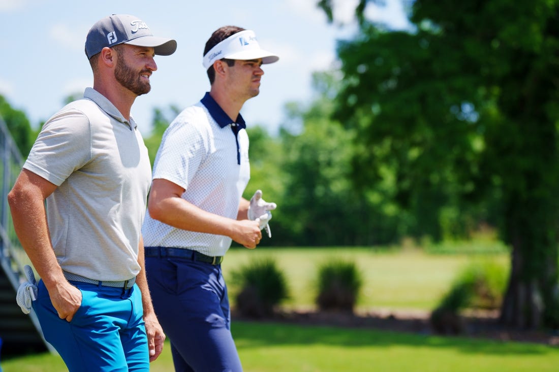 Apr 20, 2023; Avondale, Louisiana, USA; Wyndham Clark and Beau Hossler walk off the first tee during the first round of the Zurich Classic of New Orleans golf tournament. Mandatory Credit: Andrew Wevers-USA TODAY Sports