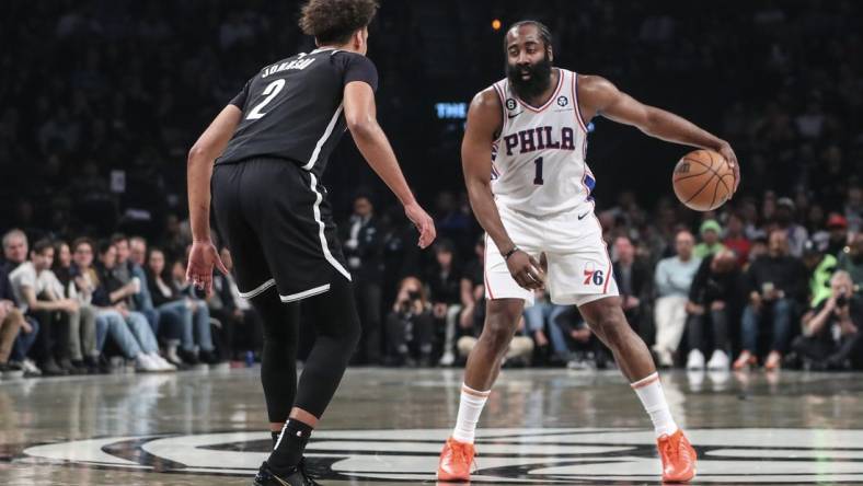 Apr 20, 2023; Brooklyn, New York, USA; Philadelphia 76ers guard James Harden (1) looks to drive past Brooklyn Nets forward Cameron Johnson (2) during game three of the 2023 NBA playoffs at Barclays Center. Mandatory Credit: Wendell Cruz-USA TODAY Sports