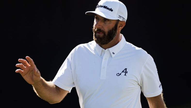 Apr 21, 2023; Adelaide, South Australia AUS;  Dustin Johnson of team Aces waves to the crowd on the twelfth hole during the first round of LIV Golf Adelaide golf tournament at Grange Golf Club. Mandatory Credit: Mike Frey-USA TODAY Sports