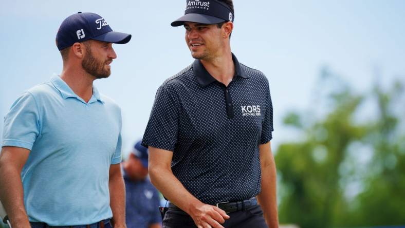 Apr 21, 2023; Avondale, Louisiana, USA; Wyndham Clark and Beau Hossler walk the eighth fairway during the second round of the Zurich Classic of New Orleans golf tournament. Mandatory Credit: Andrew Wevers-USA TODAY Sports