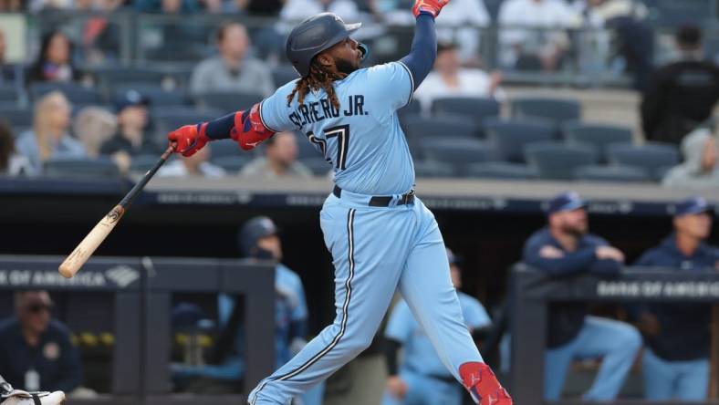 Apr 21, 2023; Bronx, New York, USA; Toronto Blue Jays first baseman Vladimir Guerrero Jr. (27) hits a two run home run during the first inning against the New York Yankees at Yankee Stadium. Mandatory Credit: Vincent Carchietta-USA TODAY Sports