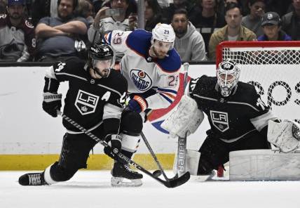 Apr 21, 2023; Los Angeles, California, USA; Los Angeles Kings goaltender Joonas Korpisalo (70) defends the net as center Phillip Danault (24) clears the puck in front of Edmonton Oilers center Leon Draisaitl (29) in the second period of game three of the first round of the 2023 Stanley Cup Playoffs at Crypto.com Arena. Mandatory Credit: Jayne Kamin-Oncea-USA TODAY Sports