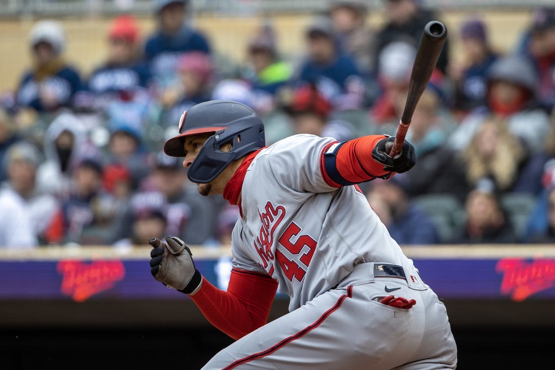 Apr 22, 2023; Minneapolis, Minnesota, USA; Washington Nationals first baseman Joey Meneses (45) hits a RBI ground ball in the first inning against the Minnesota Twins at Target Field. Mandatory Credit: Jesse Johnson-USA TODAY Sports