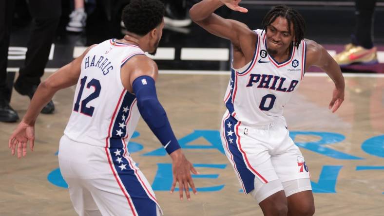 Apr 22, 2023; Brooklyn, New York, USA; Philadelphia 76ers guard Tyrese Maxey (0) celebrates with forward Tobias Harris (12) after a basket against the Brooklyn Nets during the second half of game four of the 2023 NBA playoffs at Barclays Center. Mandatory Credit: Vincent Carchietta-USA TODAY Sports