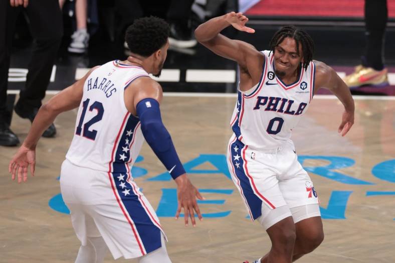 Apr 22, 2023; Brooklyn, New York, USA; Philadelphia 76ers guard Tyrese Maxey (0) celebrates with forward Tobias Harris (12) after a basket against the Brooklyn Nets during the second half of game four of the 2023 NBA playoffs at Barclays Center. Mandatory Credit: Vincent Carchietta-USA TODAY Sports