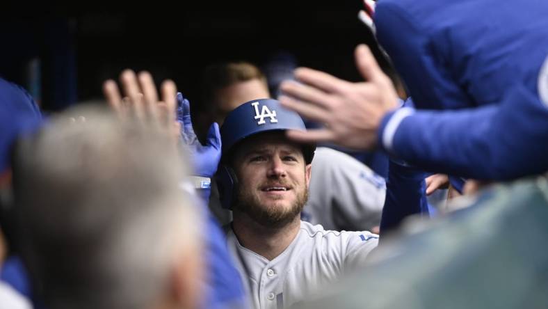 Apr 22, 2023; Chicago, Illinois, USA;Los Angeles Dodgers third baseman Max Muncy (13) celebrates in the dugout after hitting a two run home run against the Chicago Cubs during the ninth inning at Wrigley Field. Mandatory Credit: Matt Marton-USA TODAY Sports