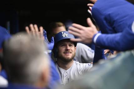 Apr 22, 2023; Chicago, Illinois, USA;Los Angeles Dodgers third baseman Max Muncy (13) celebrates in the dugout after hitting a two run home run against the Chicago Cubs during the ninth inning at Wrigley Field. Mandatory Credit: Matt Marton-USA TODAY Sports