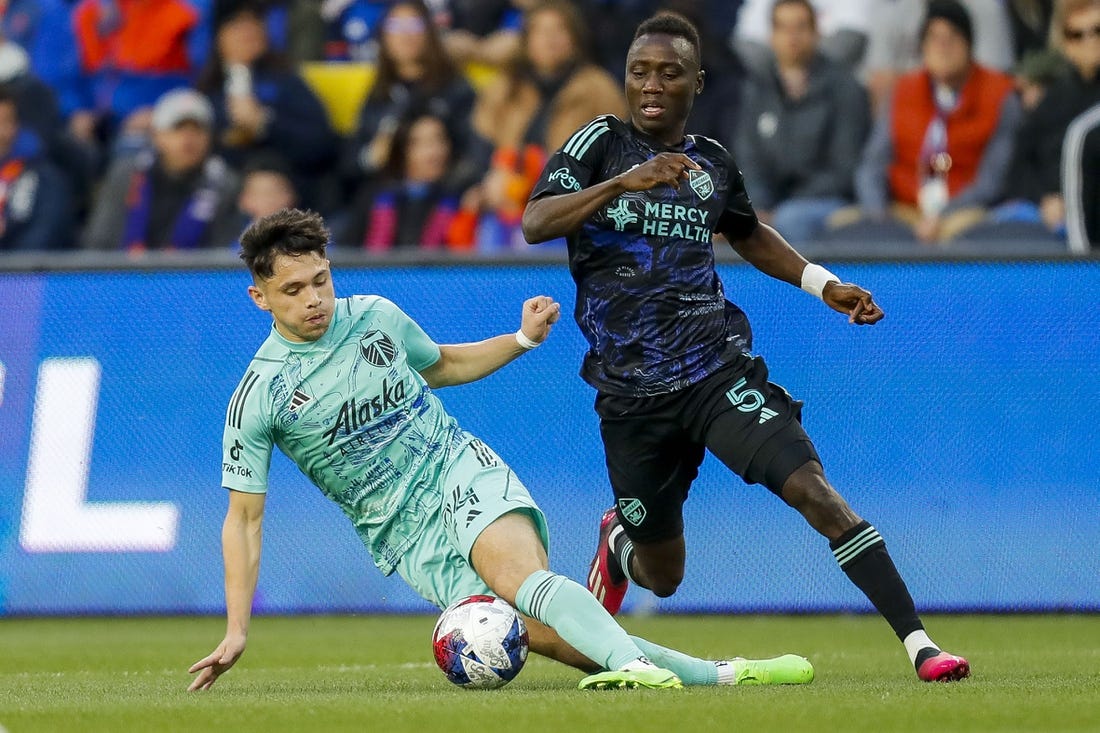 Apr 22, 2023; Cincinnati, Ohio, USA; Portland Timbers midfielder David Ayala (24) dribbles against FC Cincinnati midfielder Obinna Nwobodo (5) in the first half at TQL Stadium. Mandatory Credit: Katie Stratman-USA TODAY Sports