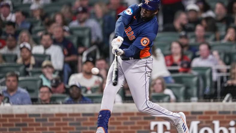 Apr 22, 2023; Cumberland, Georgia, USA; Houston Astros designated hitter Yordan Alvarez (44) hits a two run home run against the Atlanta Braves during the sixth inning at Truist Park. Mandatory Credit: Dale Zanine-USA TODAY Sports