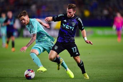 Apr 22, 2023; Carson, California, USA; Los Angeles Galaxy midfielder Tyler Boyd (11) moves the ball against Austin FC forward Jon Gallagher (17) during the first half at Dignity Health Sports Park. Mandatory Credit: Gary A. Vasquez-USA TODAY Sports