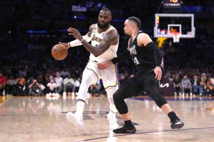 Apr 22, 2023; Los Angeles, California, USA; Los Angeles Lakers forward LeBron James (6) dribbles the ball against Memphis Grizzlies forward Dillon Brooks (24) in the second quarter during game three of the 2023 NBA playoffs at Crypto.com Arena. Mandatory Credit: Kirby Lee-USA TODAY Sports