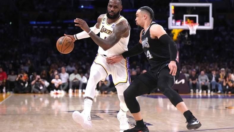 Apr 22, 2023; Los Angeles, California, USA; Los Angeles Lakers forward LeBron James (6) dribbles the ball against Memphis Grizzlies forward Dillon Brooks (24) in the second quarter during game three of the 2023 NBA playoffs at Crypto.com Arena. Mandatory Credit: Kirby Lee-USA TODAY Sports