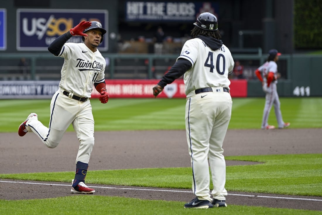 Apr 23, 2023; Minneapolis, Minnesota, USA;  Minnesota Twins infielder Jorge Polanco (11) celebrates his solo home run against the Washington Nationals with third base coach Tommy Watkins (40) during the fourth inning at Target Field. Mandatory Credit: Nick Wosika-USA TODAY Sports