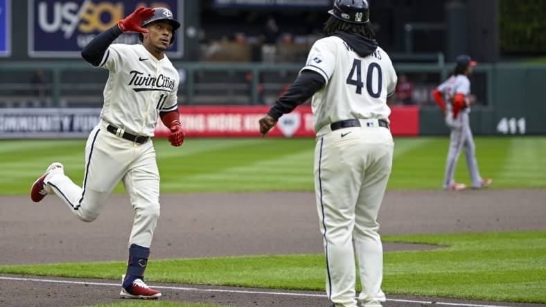 Apr 23, 2023; Minneapolis, Minnesota, USA;  Minnesota Twins infielder Jorge Polanco (11) celebrates his solo home run against the Washington Nationals with third base coach Tommy Watkins (40) during the fourth inning at Target Field. Mandatory Credit: Nick Wosika-USA TODAY Sports