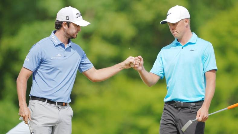 Apr 23, 2023; Avondale, Louisiana, USA; Davis Riley fist bumps Nick Hardy on the 16th green during the final round of the Zurich Classic of New Orleans golf tournament. Mandatory Credit: Andrew Wevers-USA TODAY Sports