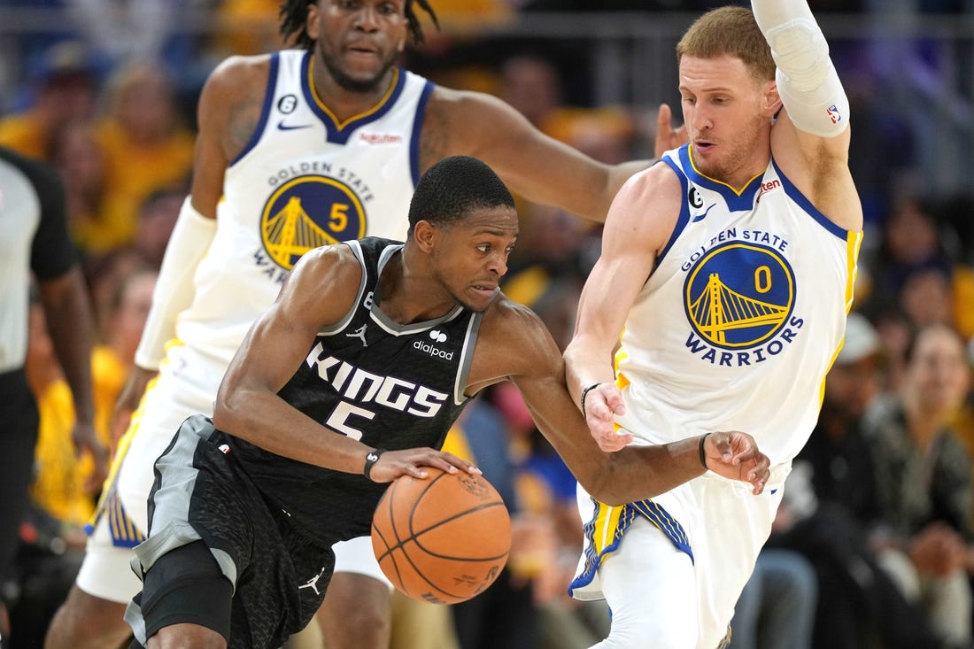 Apr 23, 2023; San Francisco, California, USA; Sacramento Kings guard Malik Monk (0) dribbles against Golden State Warriors guard Donte DiVincenzo (0) during the third quarter of game four of the 2023 NBA playoffs at Chase Center. Mandatory Credit: Darren Yamashita-USA TODAY Sports