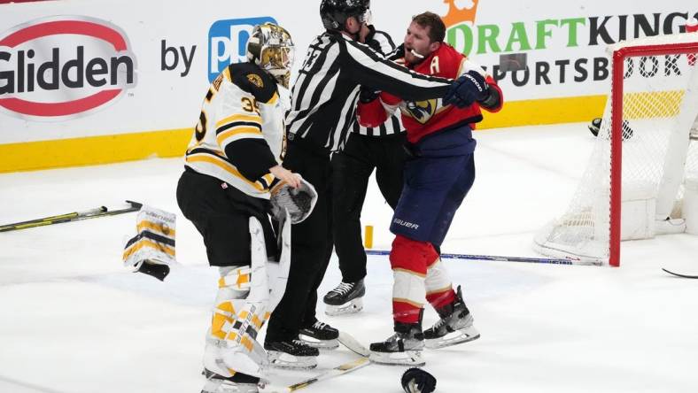 Apr 23, 2023; Sunrise, Florida, USA; Florida Panthers left wing Matthew Tkachuk (19) and Boston Bruins goaltender Linus Ullmark (35) are separated by the linesmen after a line brawl during the third period of game four in the first round of the 2023 Stanley Cup Playoffs at FLA Live Arena. Mandatory Credit: Jasen Vinlove-USA TODAY Sports