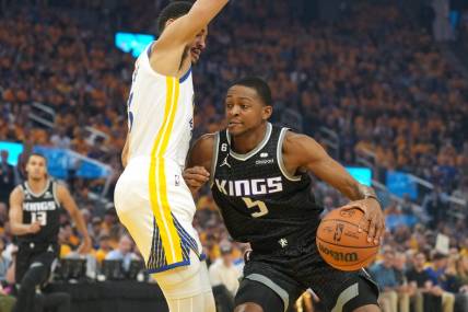 Apr 23, 2023; San Francisco, California, USA; Sacramento Kings guard De'Aaron Fox (5) dribbles against Golden State Warriors guard Jordan Poole (left) during the first quarter of game four of the 2023 NBA playoffs at Chase Center. Mandatory Credit: Darren Yamashita-USA TODAY Sports