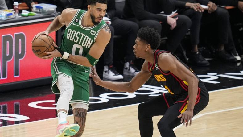 Apr 23, 2023; Atlanta, Georgia, USA; Boston Celtics forward Jayson Tatum (0) controls the ball against Atlanta Hawks forward De'Andre Hunter (12) during the first quarter during game four of the 2023 NBA playoffs at State Farm Arena. Mandatory Credit: Dale Zanine-USA TODAY Sports