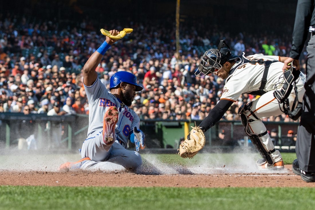 Apr 23, 2023; San Francisco, California, USA; New York Mets right fielder Starling Marte (6) slides home to score in front of San Francisco Giants catcher Blake Sabol (2) during the third inning at Oracle Park. Mandatory Credit: John Hefti-USA TODAY Sports