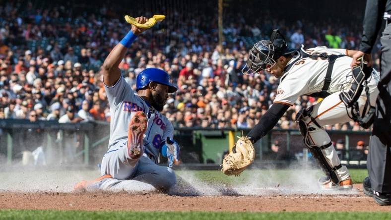 Apr 23, 2023; San Francisco, California, USA; New York Mets right fielder Starling Marte (6) slides home to score in front of San Francisco Giants catcher Blake Sabol (2) during the third inning at Oracle Park. Mandatory Credit: John Hefti-USA TODAY Sports