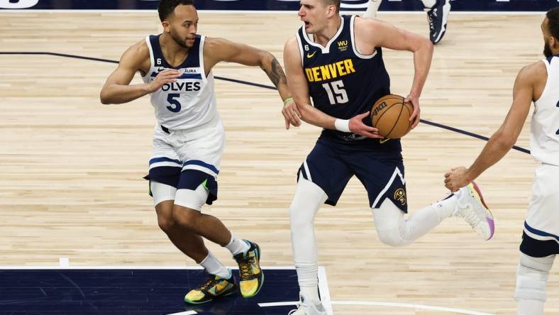 Apr 23, 2023; Minneapolis, Minnesota, USA; Denver Nuggets center Nikola Jokic (15) drives to the basket while Minnesota Timberwolves forward Kyle Anderson (5) defends during the first quarter of game four of the 2023 NBA Playoffs at Target Center. Mandatory Credit: Matt Krohn-USA TODAY Sports