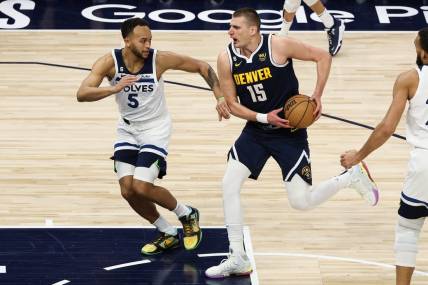 Apr 23, 2023; Minneapolis, Minnesota, USA; Denver Nuggets center Nikola Jokic (15) drives to the basket while Minnesota Timberwolves forward Kyle Anderson (5) defends during the first quarter of game four of the 2023 NBA Playoffs at Target Center. Mandatory Credit: Matt Krohn-USA TODAY Sports