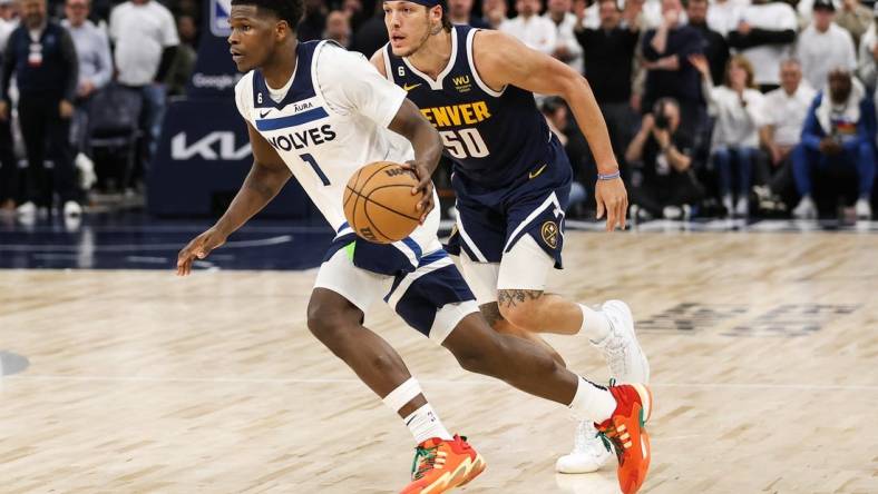 Apr 23, 2023; Minneapolis, Minnesota, USA; Minnesota Timberwolves guard Anthony Edwards (1) drives while Denver Nuggets forward Aaron Gordon (50) defends during overtime of game four of the 2023 NBA Playoffs at Target Center. Mandatory Credit: Matt Krohn-USA TODAY Sports